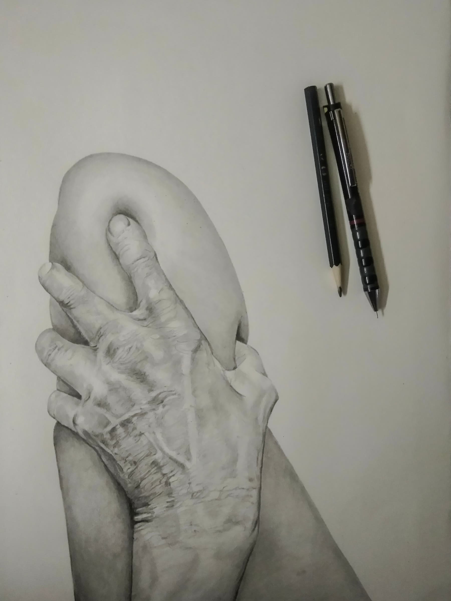 Graphite drawing of an old hand gripping a leg, with pencils beside it
